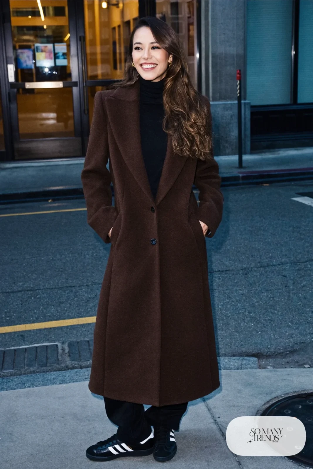 Woman in long chocolate brown wool coat, black turtleneck, black knit pants and black Adidas Campus sneakers, outfit 28