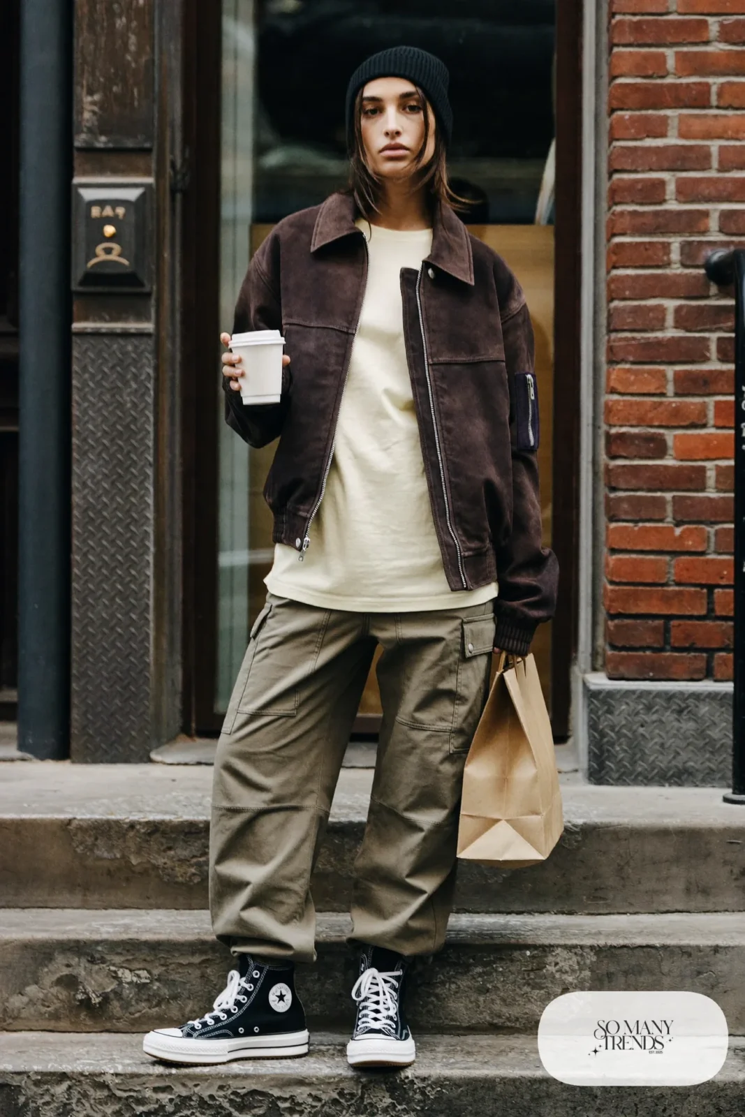 Woman in a chocolate brown suede bomber jacket, cream tee, olive cargo pants and black Converse Run Star Hike platform sneakers - outfit 6