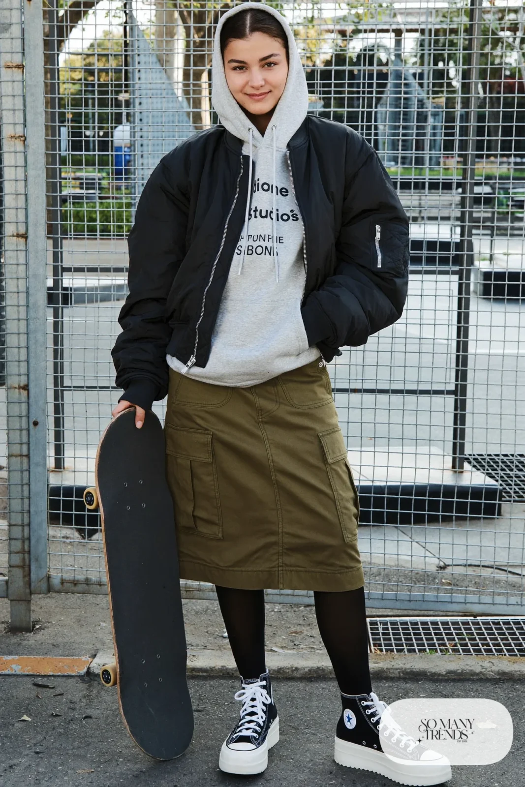 Woman in a gray hoodie, olive cargo midi skirt, black tights, cropped jacket and black Converse Run Star Hike platform sneakers - outfit 15