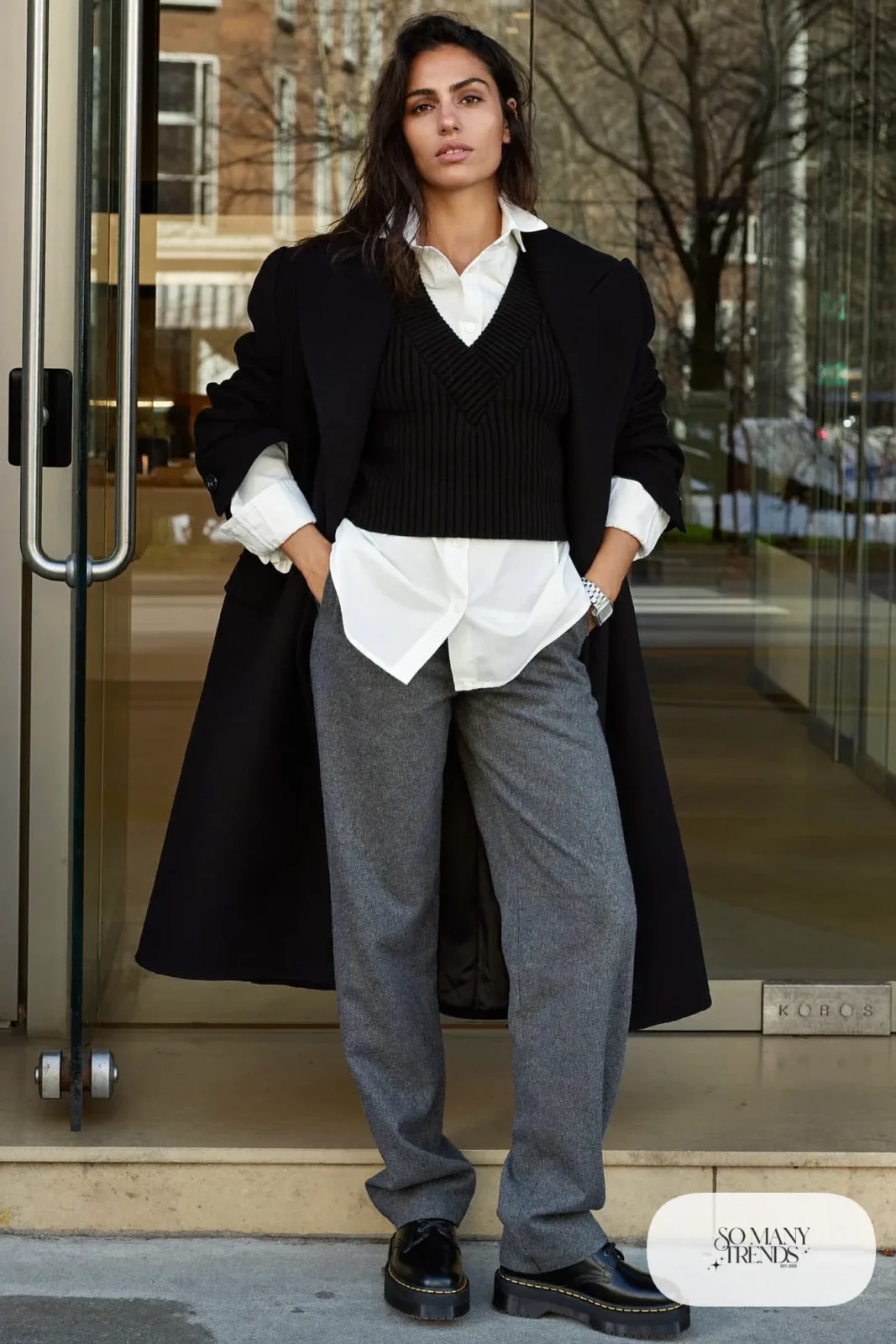 Woman in pearl white shirt, black ribbed knit vest, gray flannel straight pants and black Doc Martens loafers, outfit 4