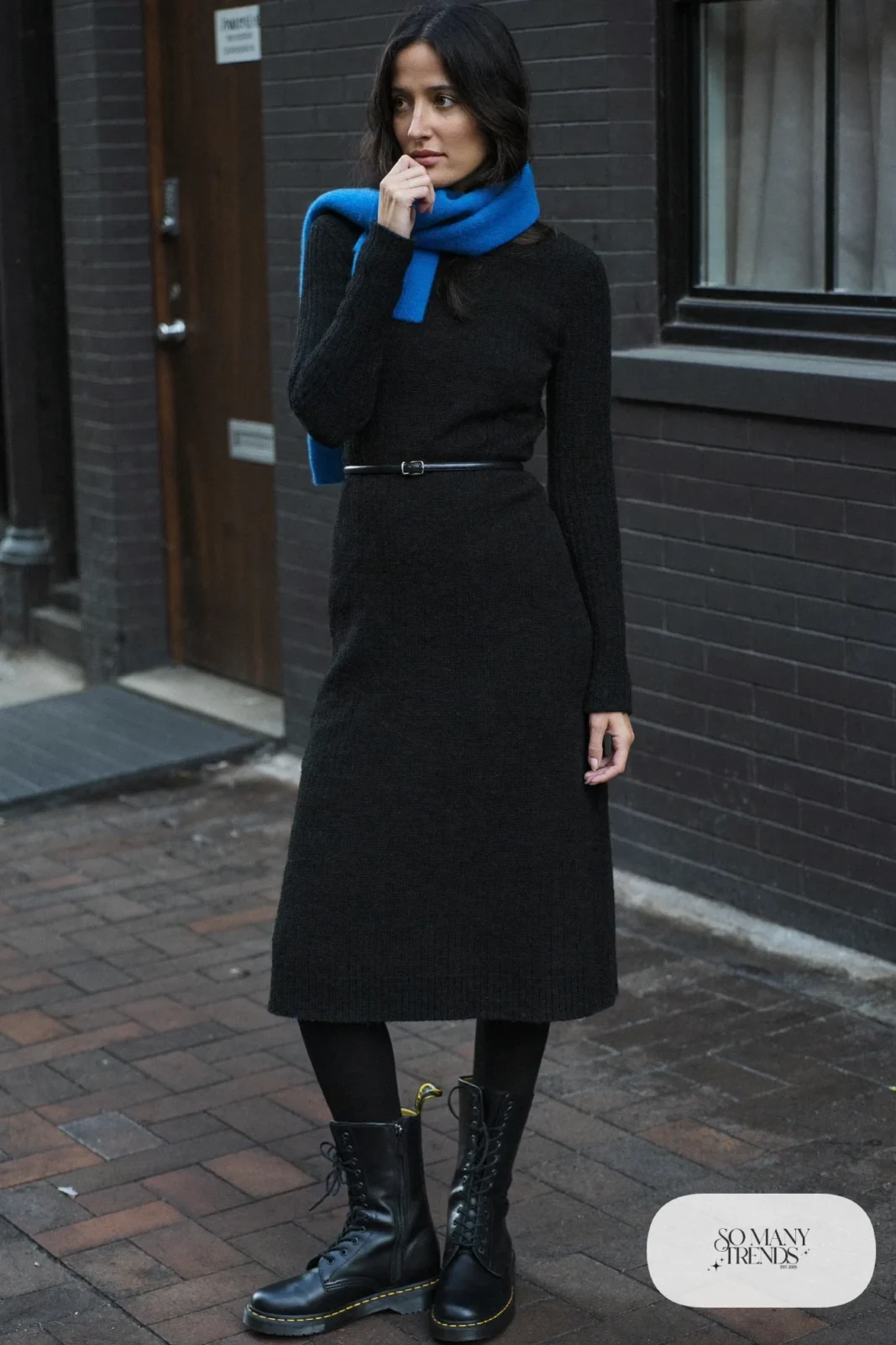Woman in black ribbed knit midi dress, cobalt scarf, opaque black tights and black Doc Martens boots, outfit 7
