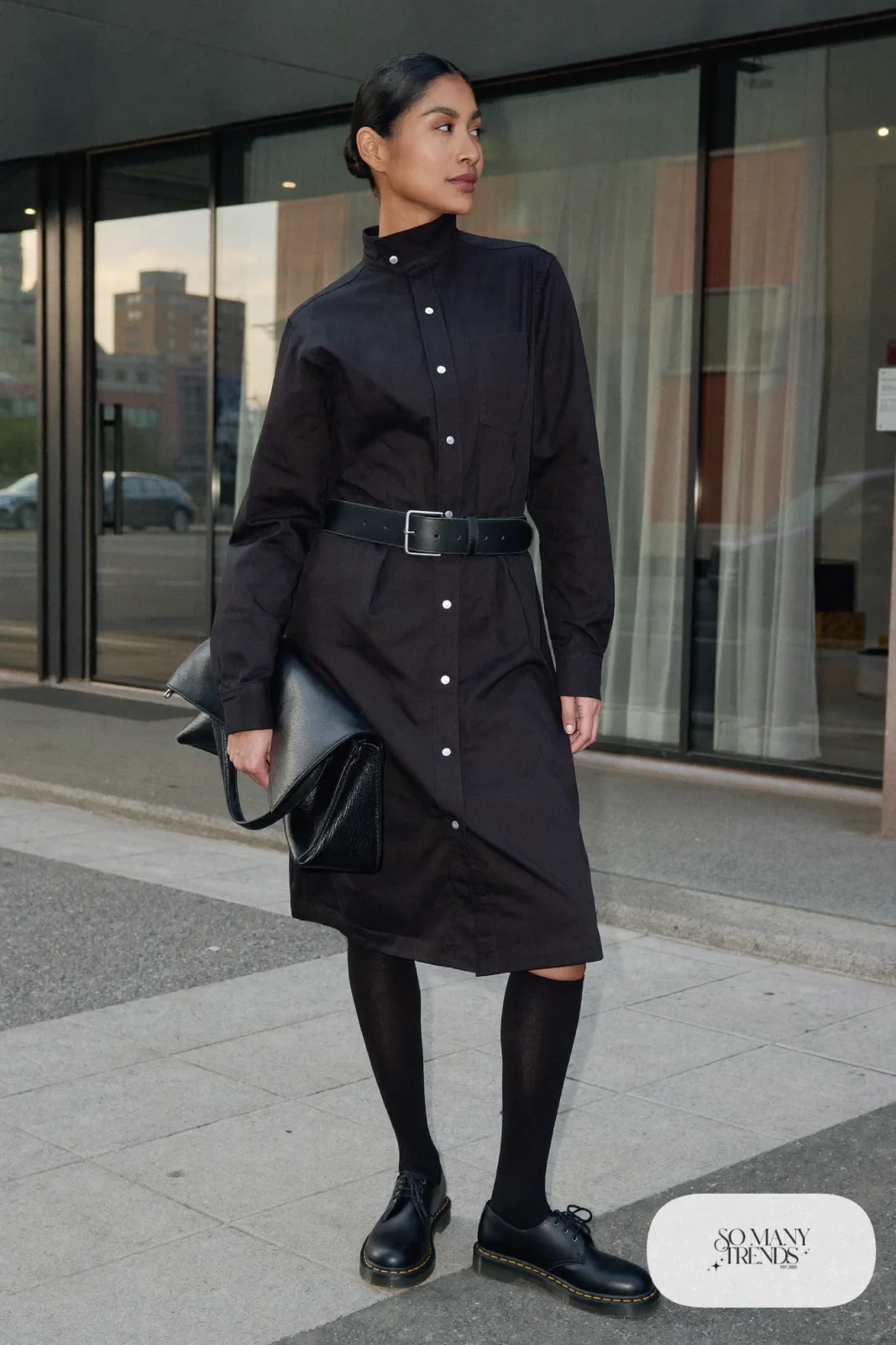 Woman in black cotton shirt dress with belt, sheer black tights and black Doc Martens loafers, outfit 12