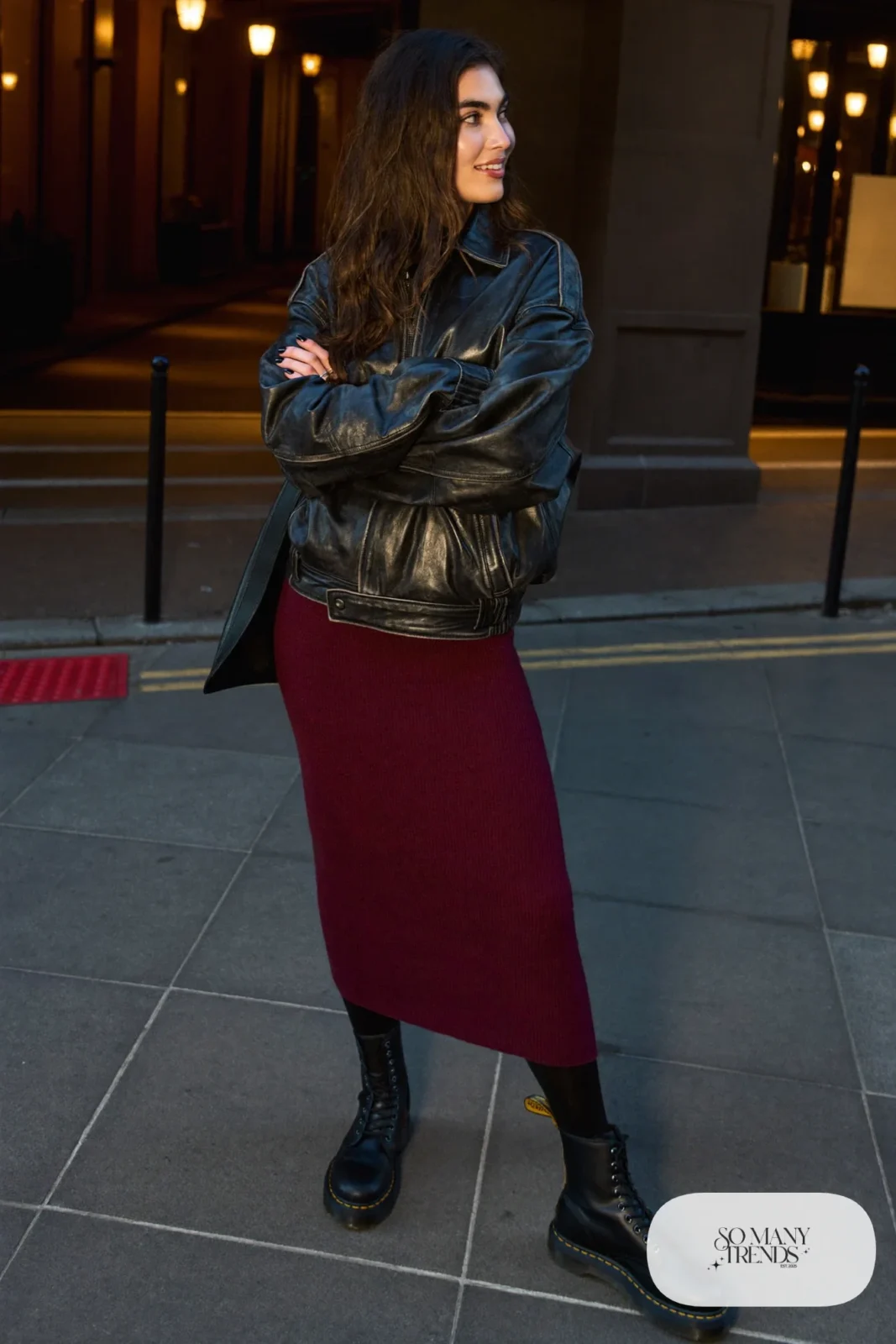 Woman in black leather jacket, burgundy knit midi dress, black opaque tights and black Doc Martens 1460 boots, outfit 17