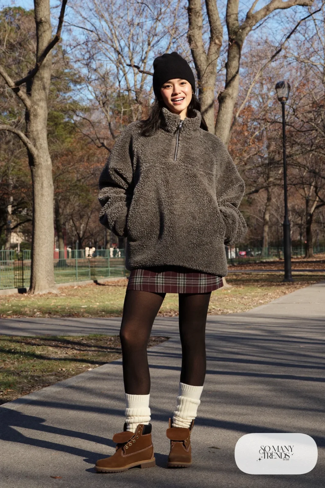 Woman in burgundy plaid mini skirt, gray fleece pullover, black tights and brown Timberland-style boots, outfit 9
