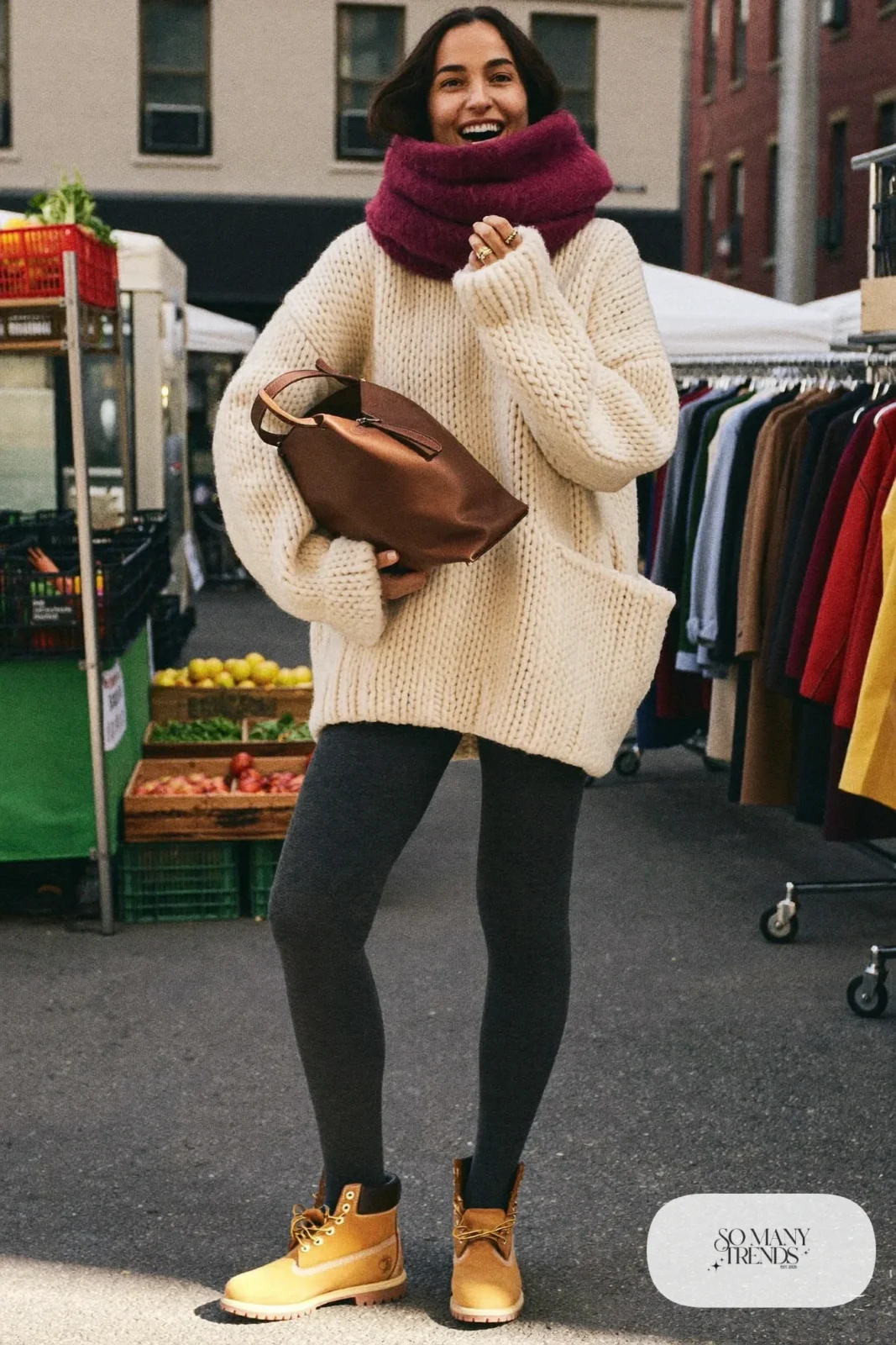 Woman in cream oversized sweater, charcoal leggings and wheat Timberland-style boots with leather tote, outfit 13