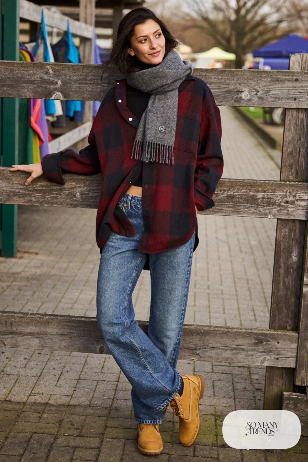 Woman in burgundy flannel shirt open over black turtleneck, straight jeans and wheat Timberland-style boots, outfit 17