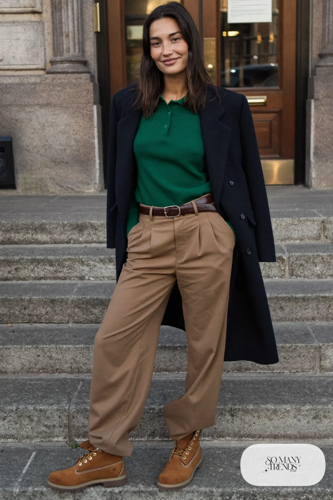 Woman in forest green knit polo sweater, camel pleated pants and brown Timberland-style boots, outfit 21