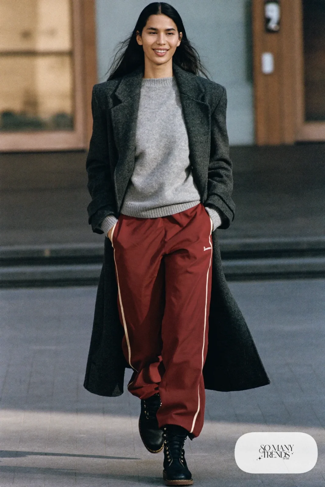 Woman in burgundy track pants, gray sweater, charcoal wool coat and black Timberland-style boots, outfit 25