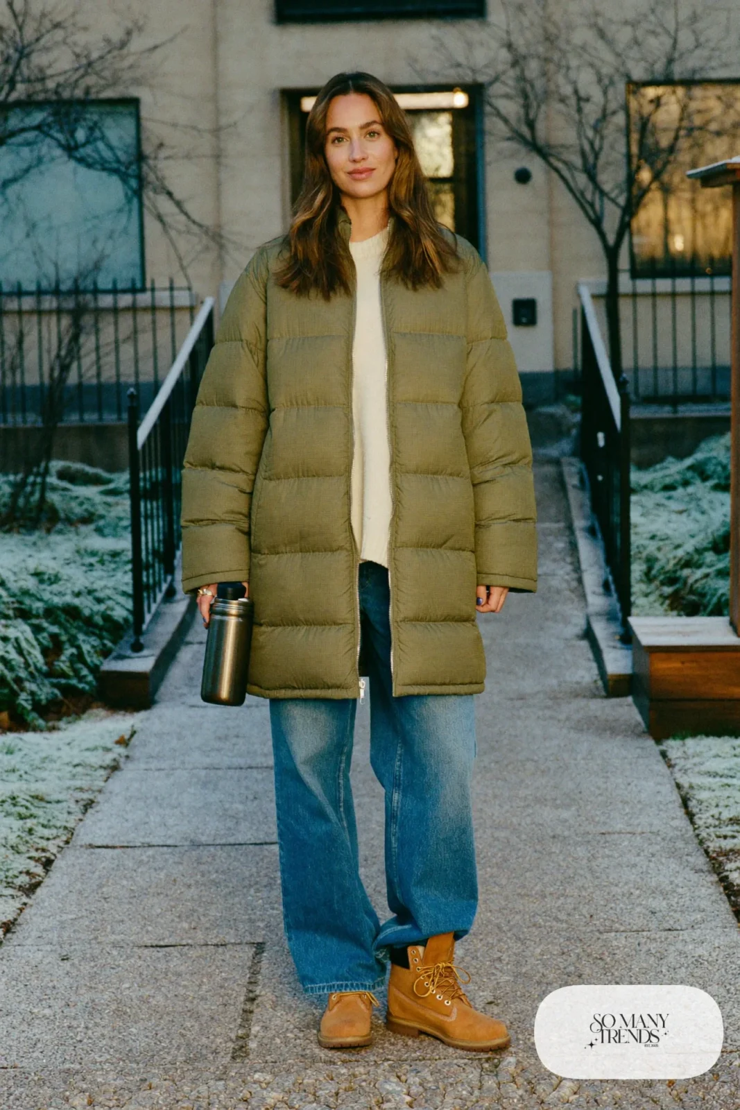 Woman in olive quilted jacket, cream sweater, wide-leg jeans and wheat Timberland-style boots, outfit 26