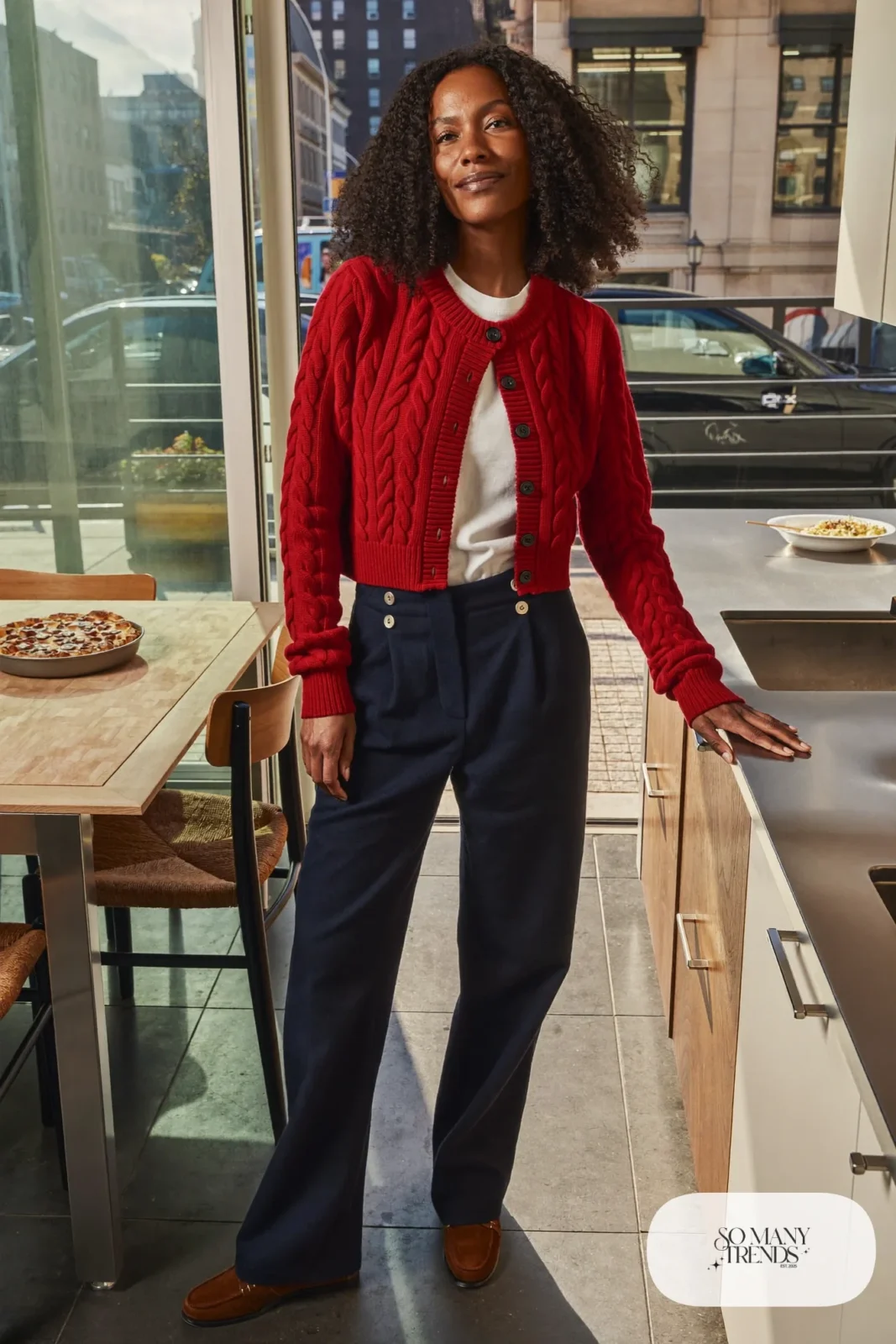 Red cable-knit cardigan over white tee with navy straight pants and brown loafers, outfit 7