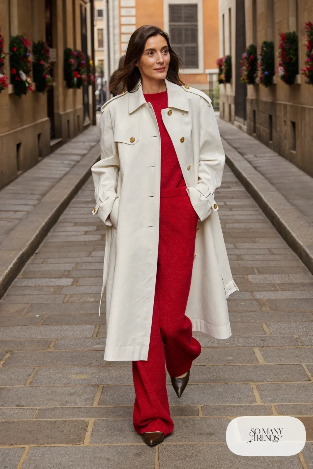 Red knit top and wide pants set under ivory trench coat with brown pointed flats, outfit 27