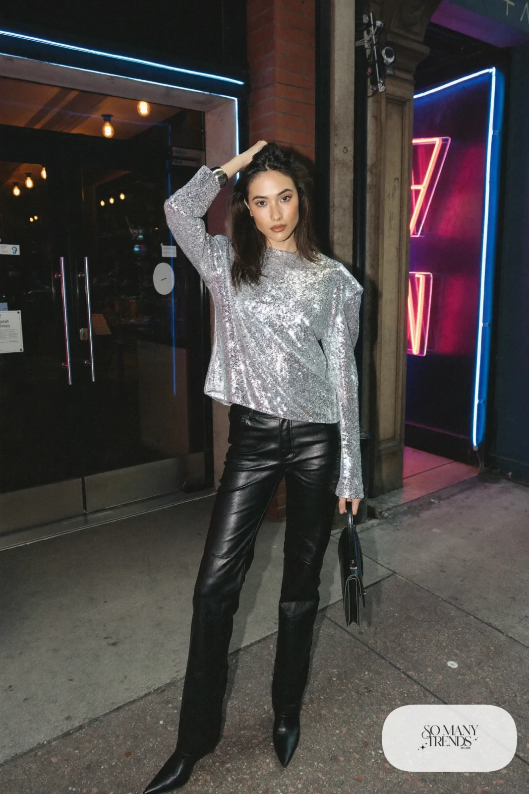 Woman in a silver sequin top, black leather straight pants and black pointed boots, New Year's Eve outfit 13