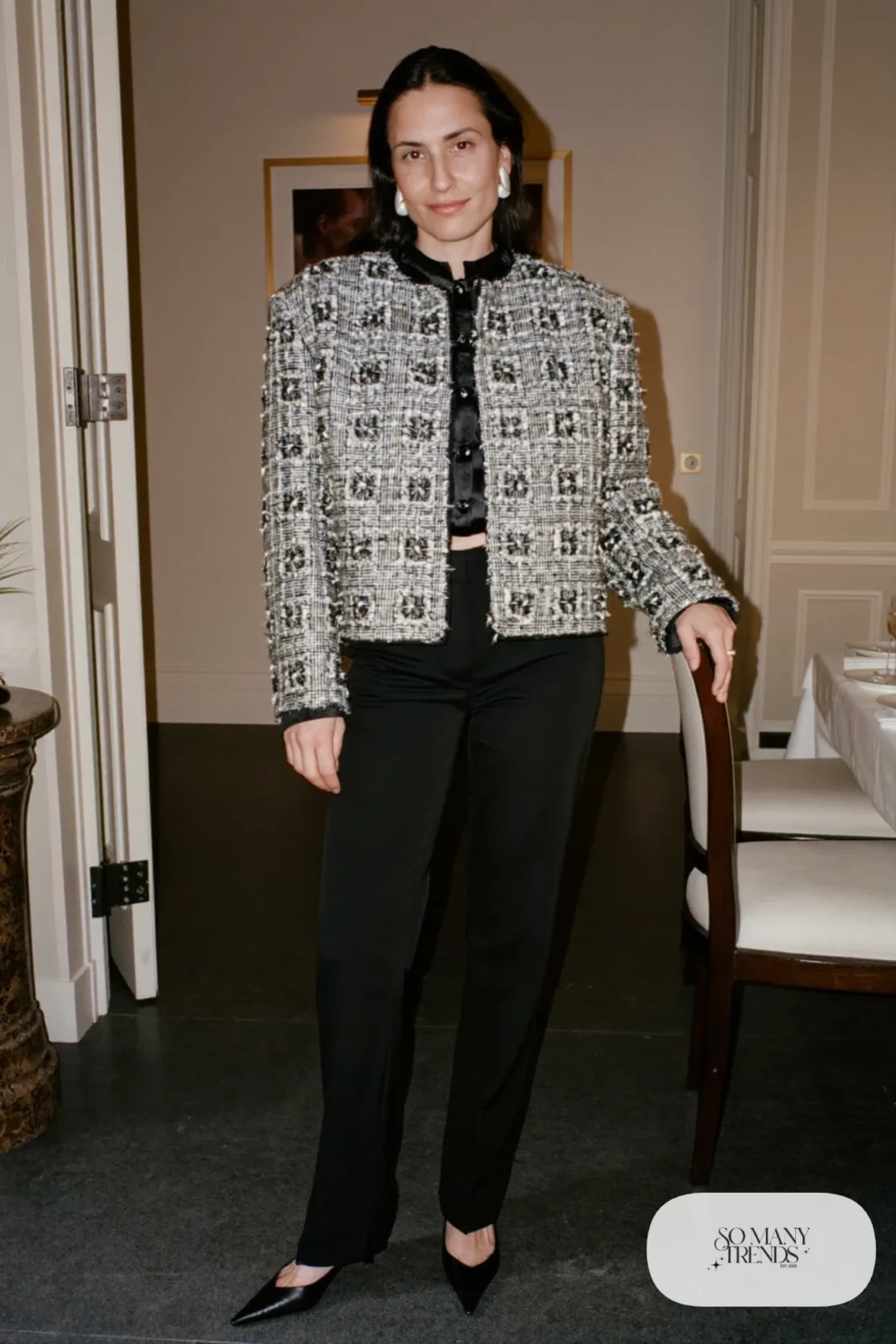 Woman in a silver-threaded tweed jacket, black silk top and black straight pants with black pumps, New Year's Eve outfit 25