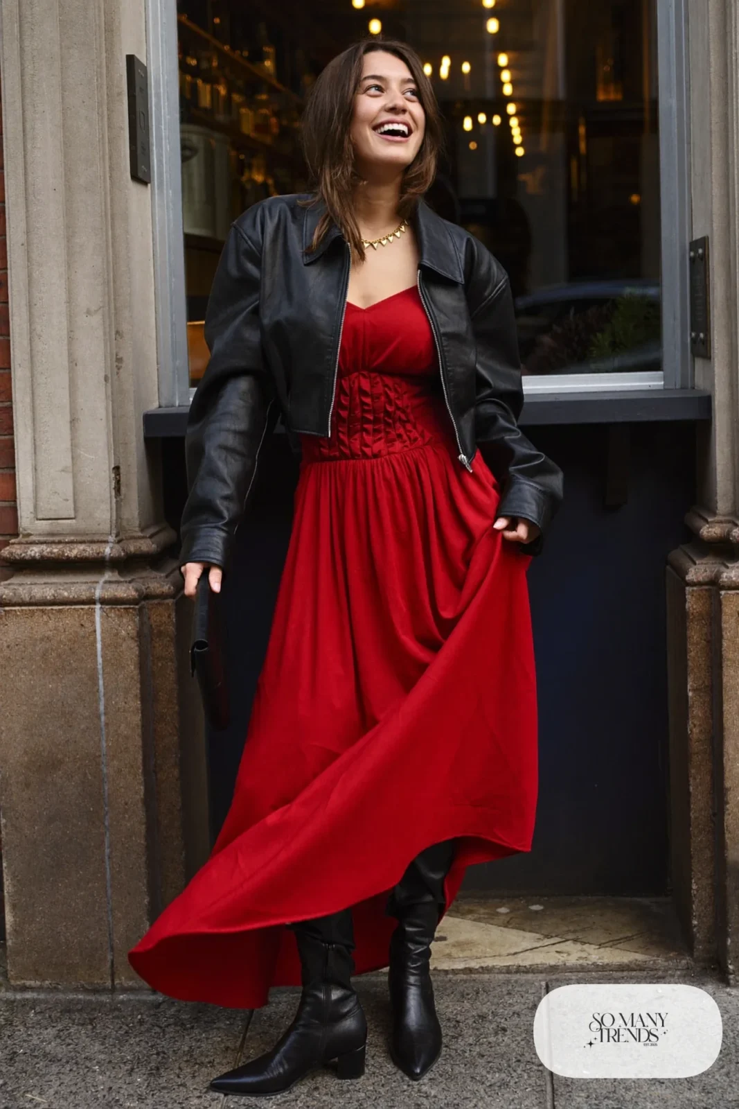 Woman in a wine red maxi dress, cropped black leather jacket and black boots, look 6