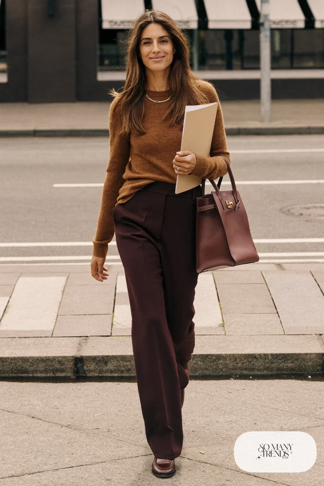 Woman in wine-red straight pants, cognac knit sweater, brown loafers and a leather tote, outfit 3