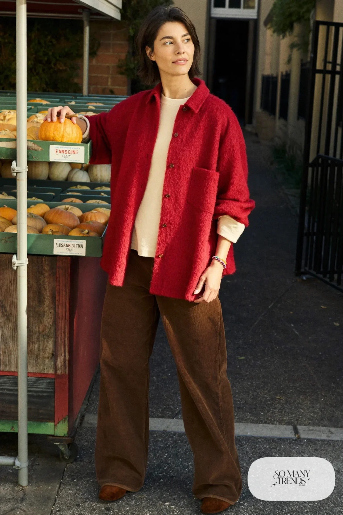 Woman in chocolate corduroy pants, wine flannel shirt over a cream tee and brown suede boots, outfit 8