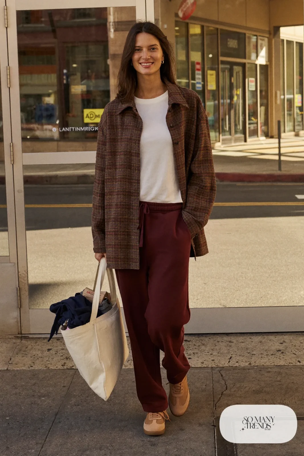 Woman in a brown plaid overshirt, white tee, burgundy sweatpants and leather sneakers, outfit 11