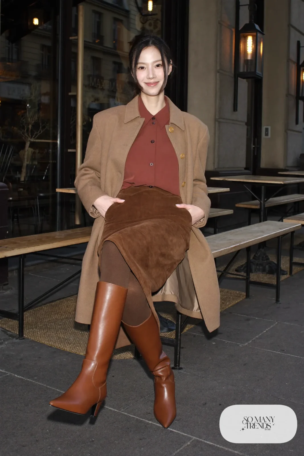 Woman in a brown faux suede midi skirt, wine crepe blouse and tan tall boots, outfit 18