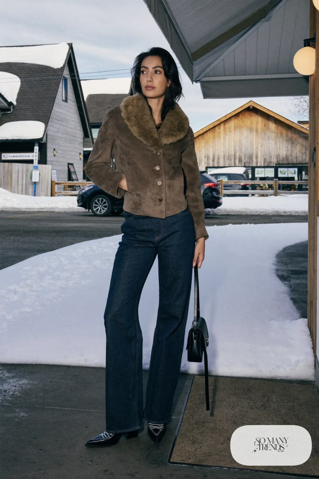 Woman in a cropped taupe shearling jacket, dark high-rise jeans and black cowboy boots, outfit 2