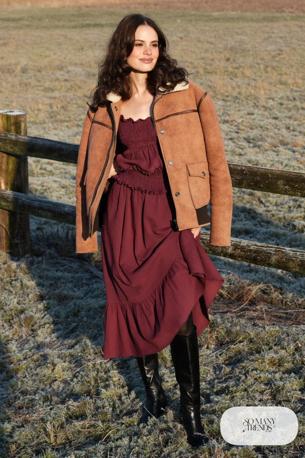 Woman in a cranberry prairie dress, shearling jacket, black tights and tall black boots, outfit 11