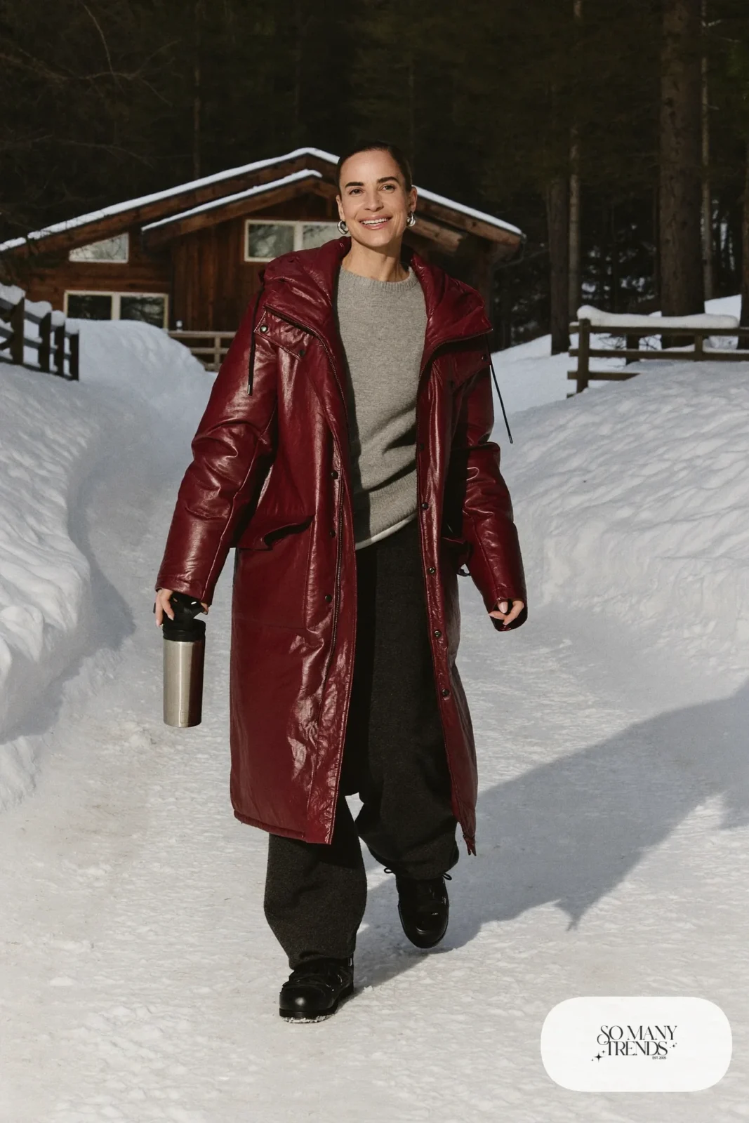 Look 4: long burgundy parka over a gray sweater and charcoal wide-leg pants with black snow boots, snowy driveway