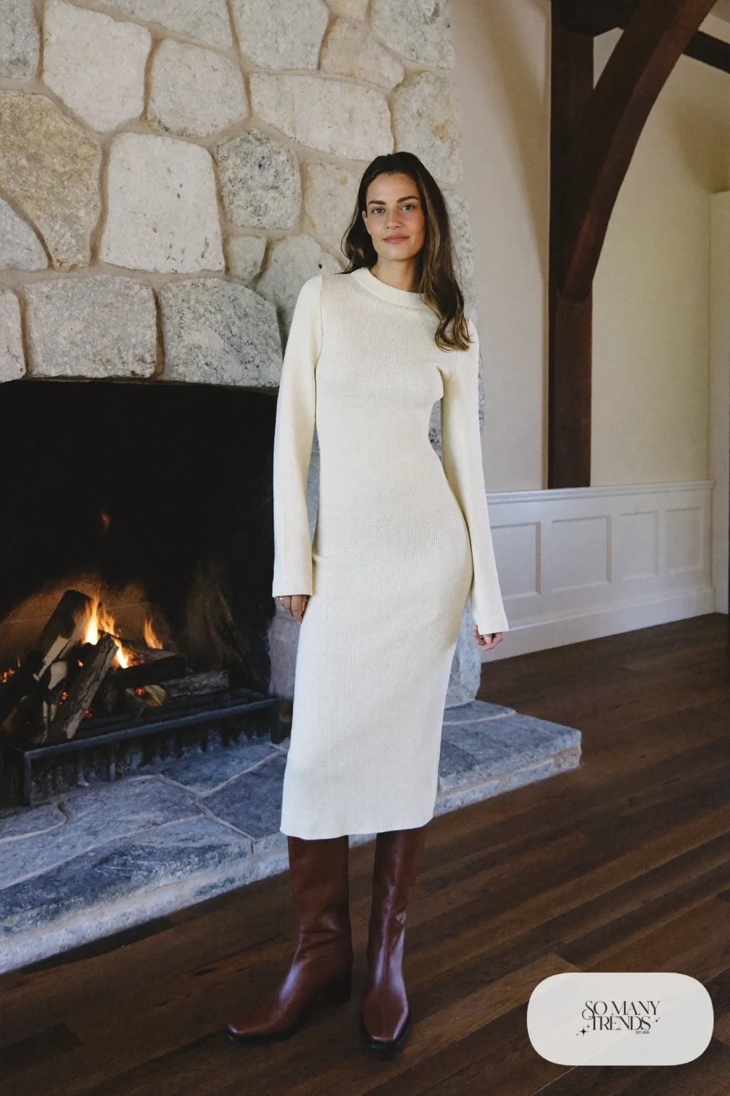 Look 29: cream rib knit maxi dress with a chocolate belt and tall brown boots, cabin great room with a fire