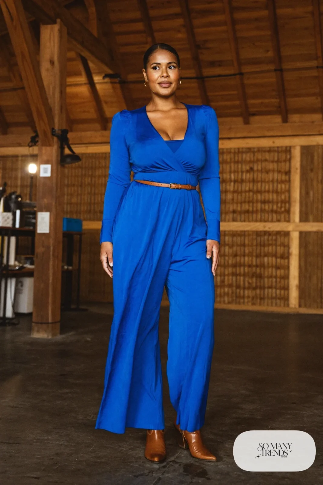 Cobalt blue wide-leg jumpsuit with camel belt and pointed brown boots, outfit 12