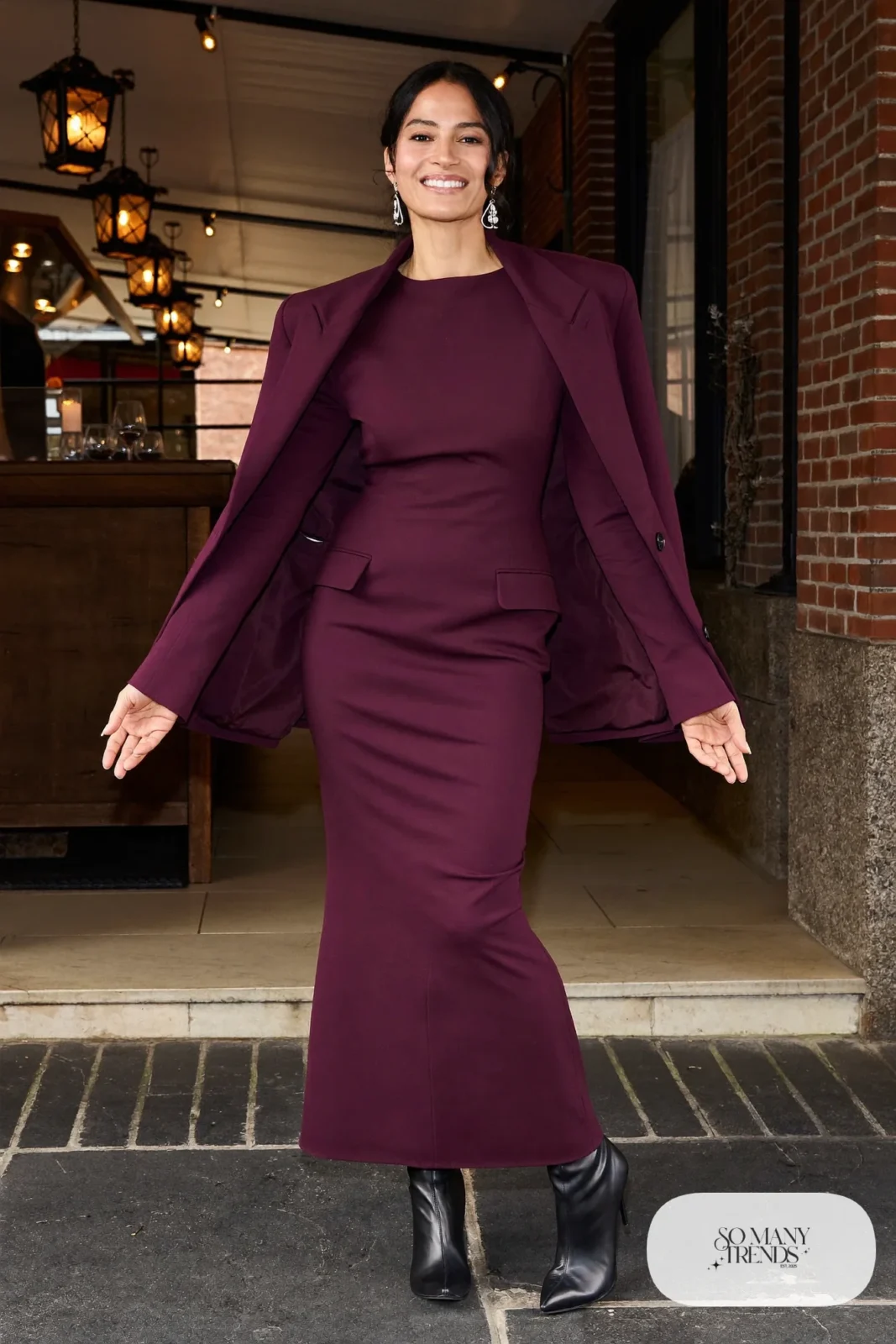 Woman in a plum column dress with a cape jacket and silver earrings, western gala outfit 11