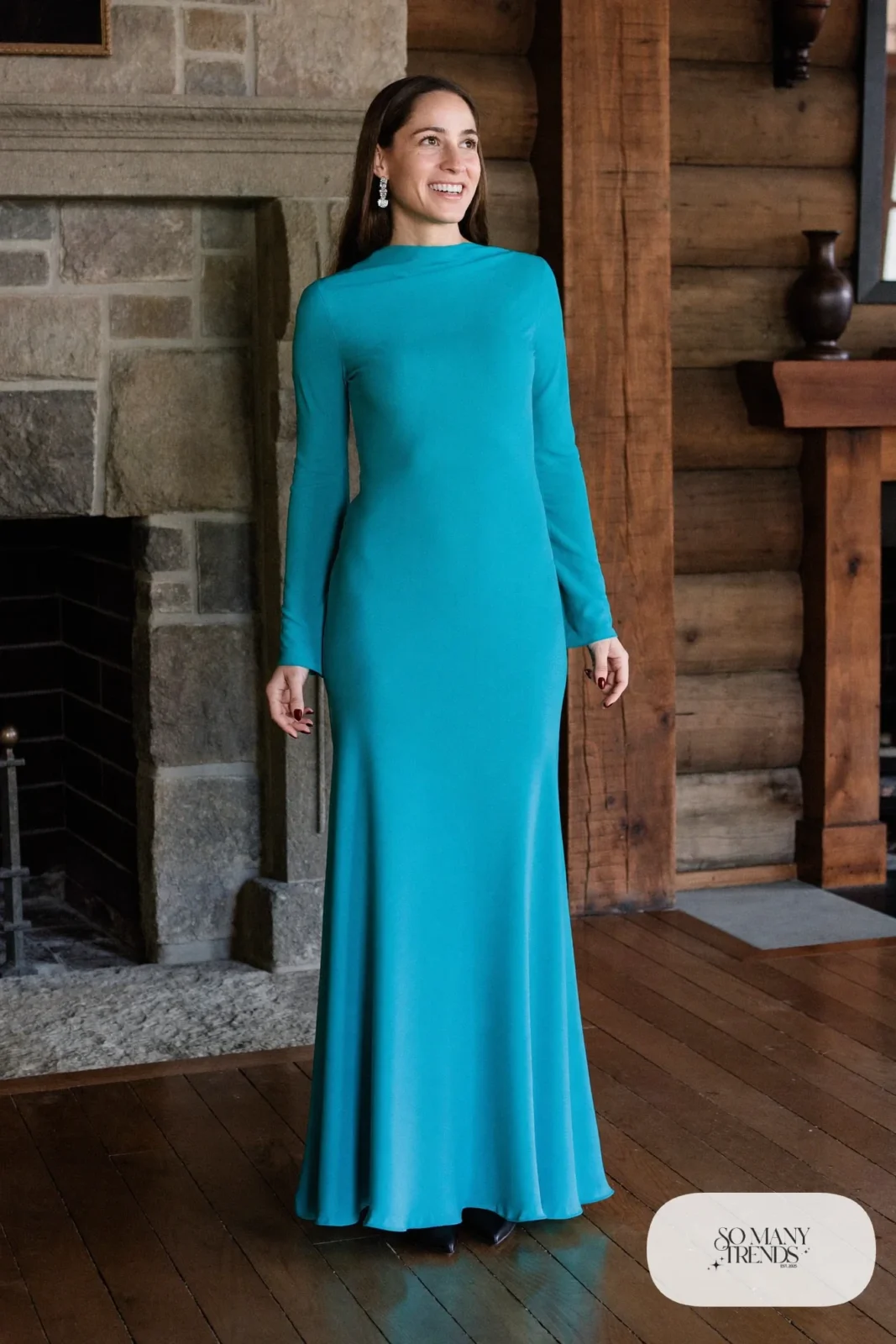 Woman in a turquoise long-sleeve gown with black accessories and heeled boots, western gala outfit 13