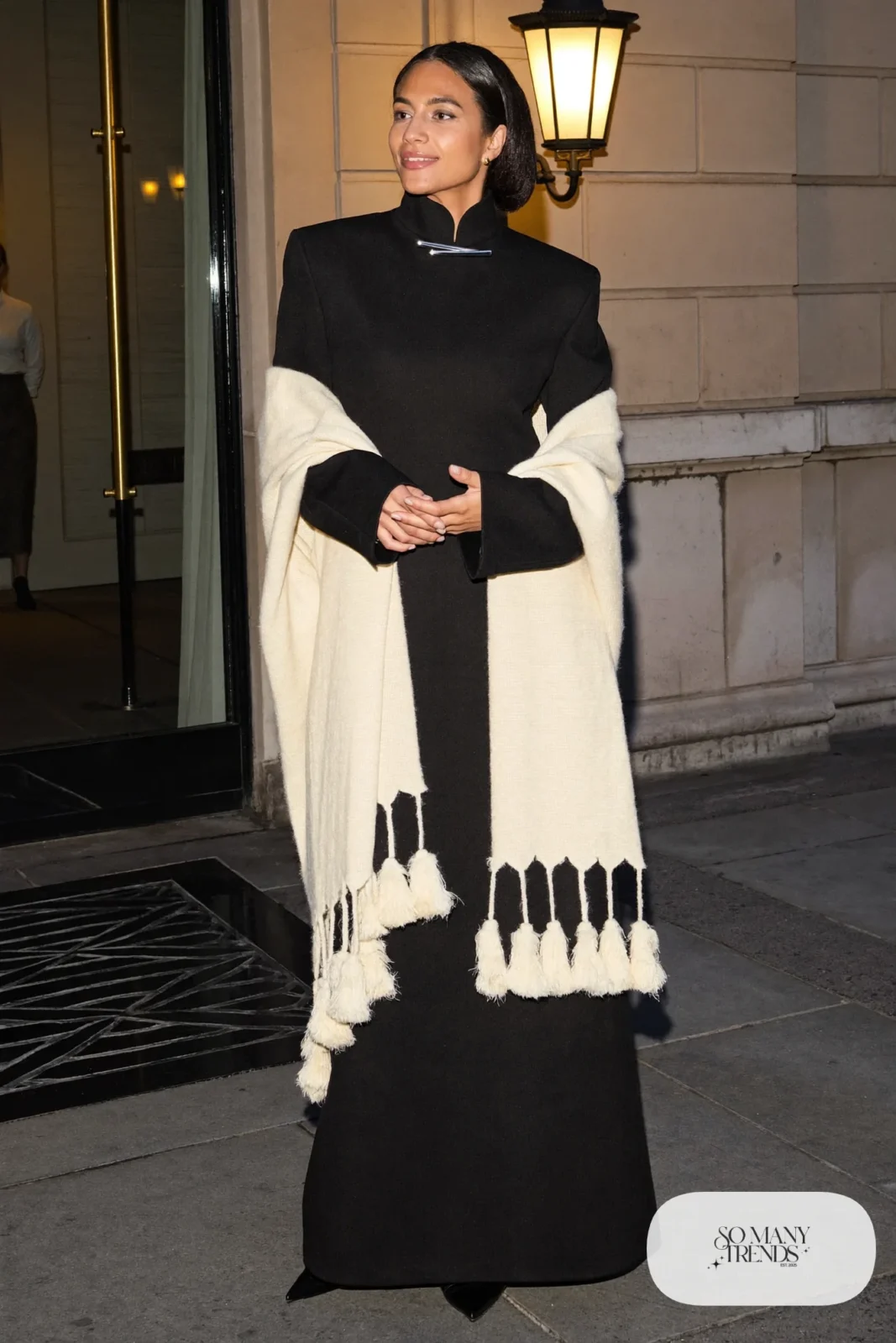 Woman in a black gown with a fringed shawl and slim bolo tie, western gala outfit 20