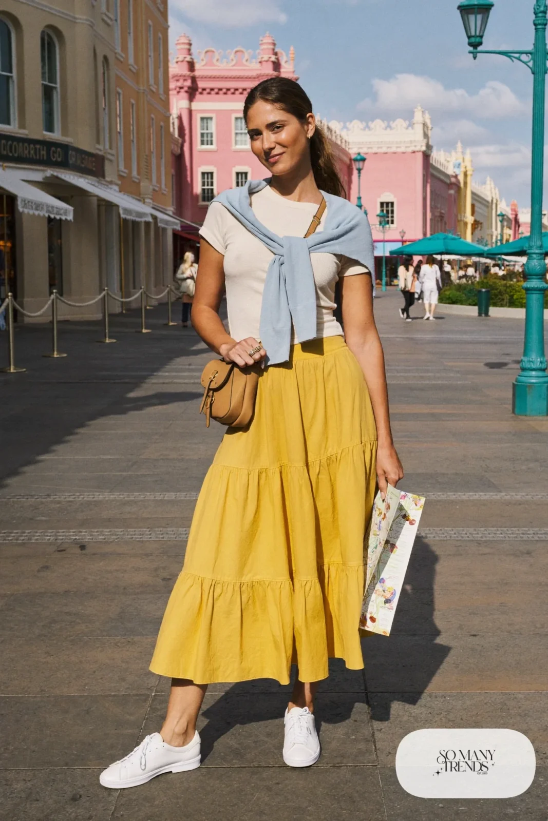Mustard yellow tiered midi skirt, ivory ribbed tee, light blue cardigan and white sneakers, outfit 1