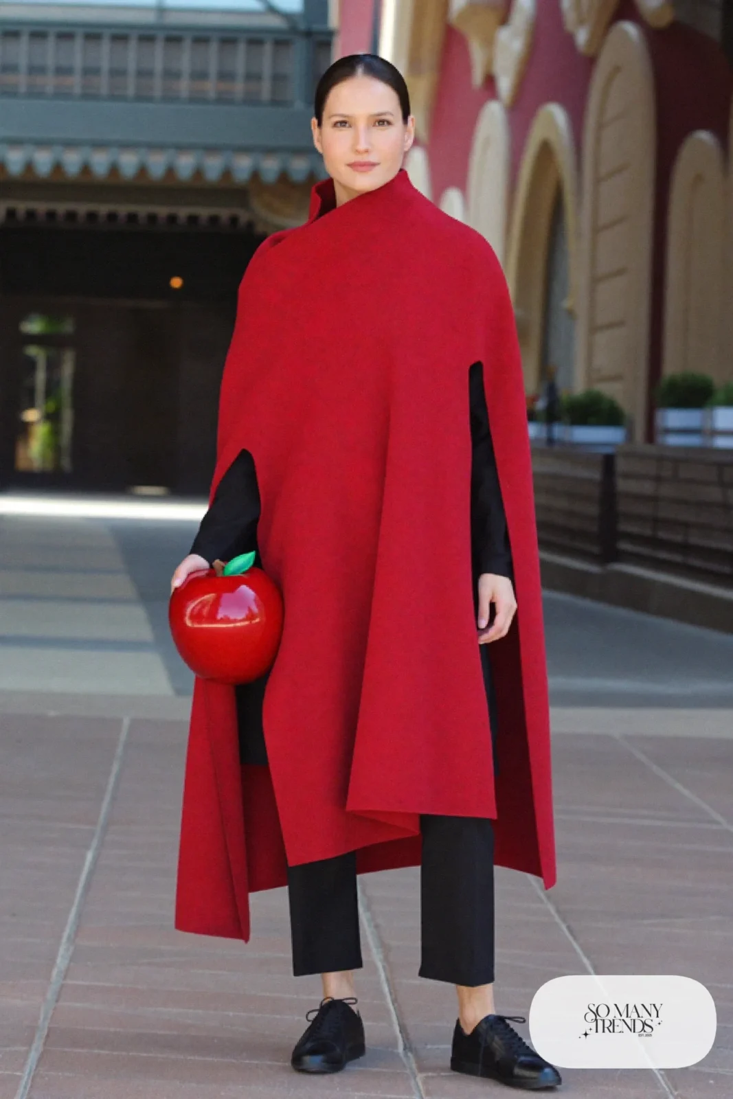Cherry red cape wrap, black sweater, black pants and sneakers, outfit 10