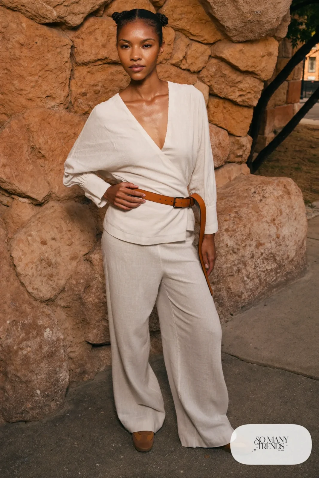 Ivory wrap top, wide-leg ivory pants, woven belt and tan sneakers, outfit 16