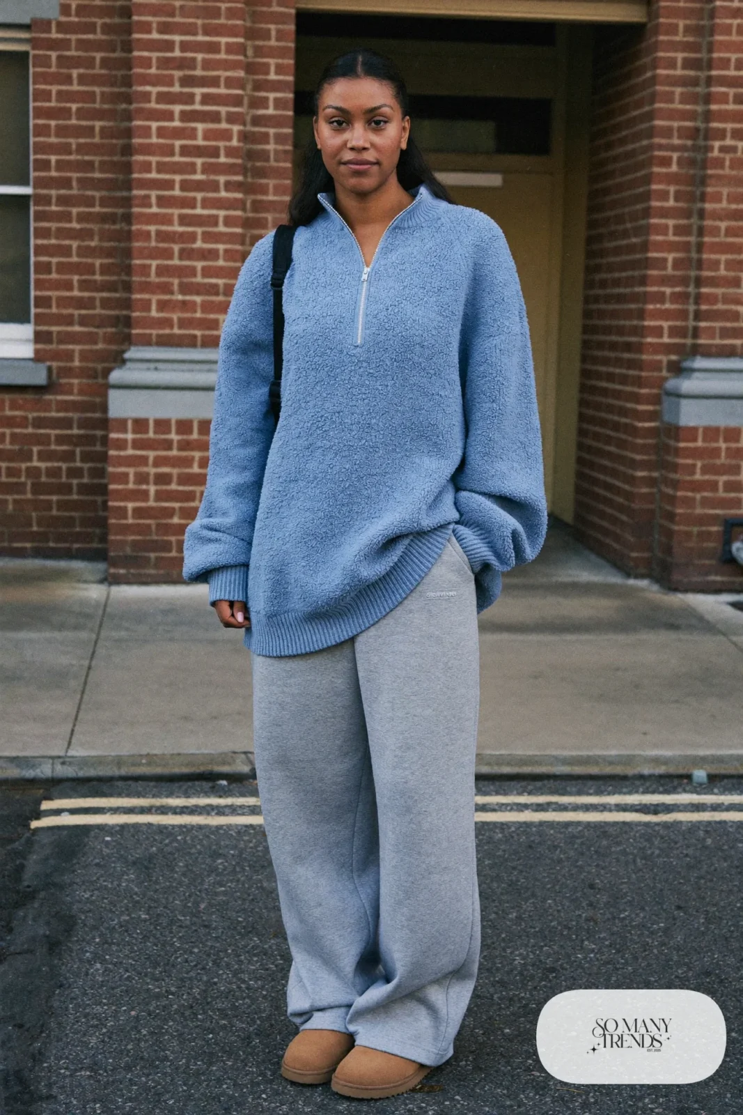Woman in gray straight sweatpants, sky blue quarter zip pullover and sand Ugg mini boots, outfit 21