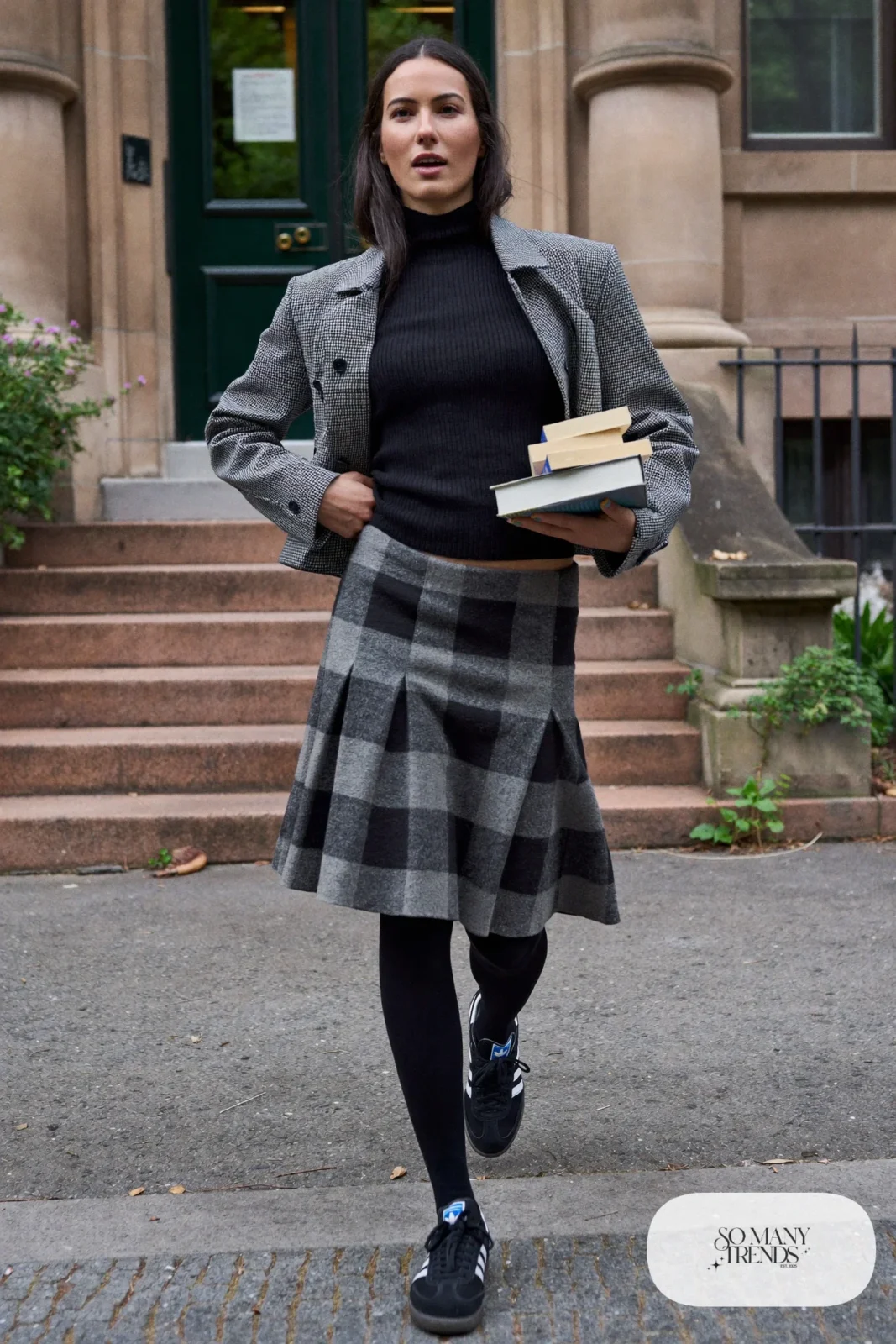 Woman in gray plaid wool skirt, black ribbed turtleneck, black tights, short black jacket and black Adidas Campus sneakers, outfit 10