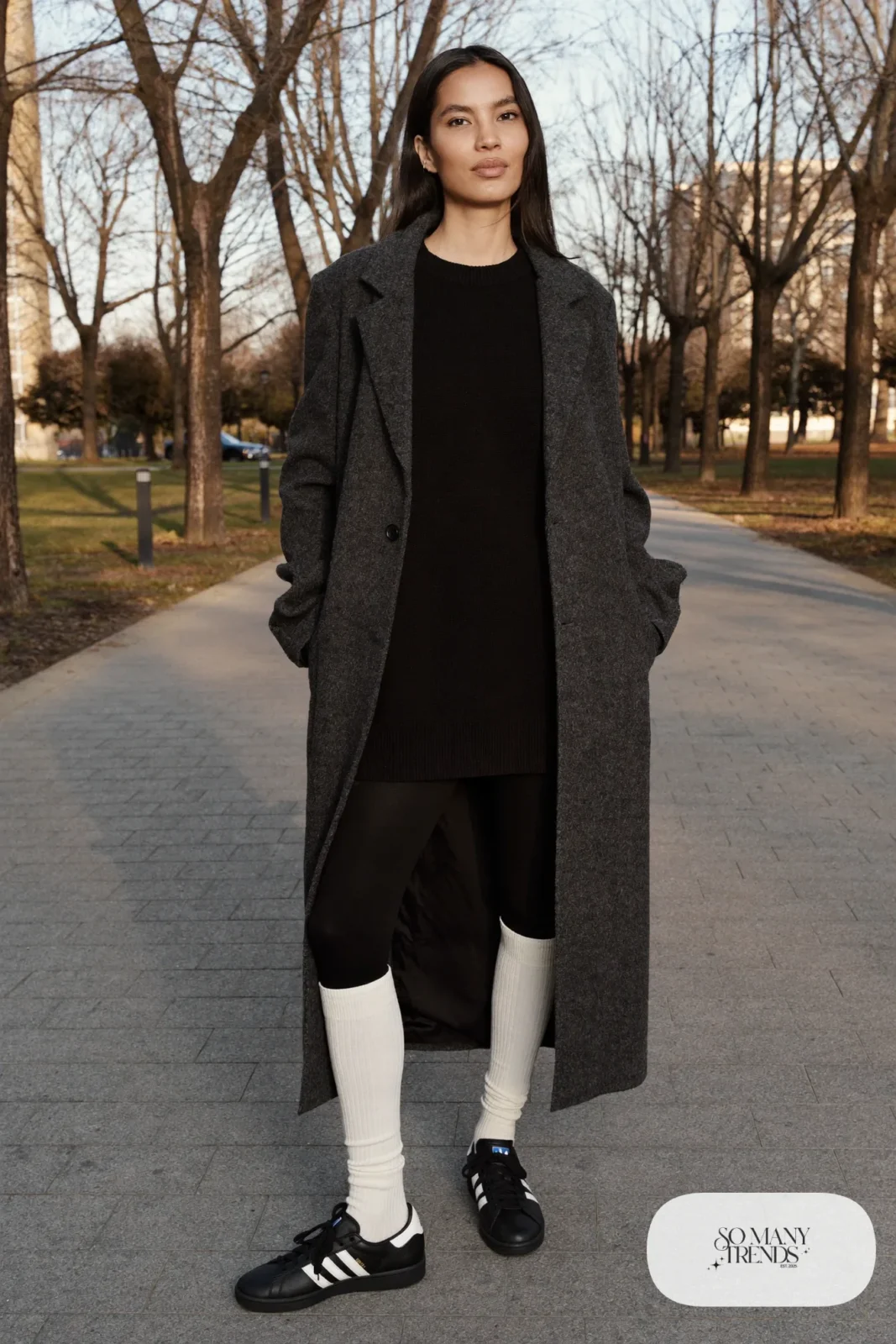 Woman in black knit sweater dress, cream ribbed tall socks, long gray coat and black Adidas Campus sneakers, outfit 14