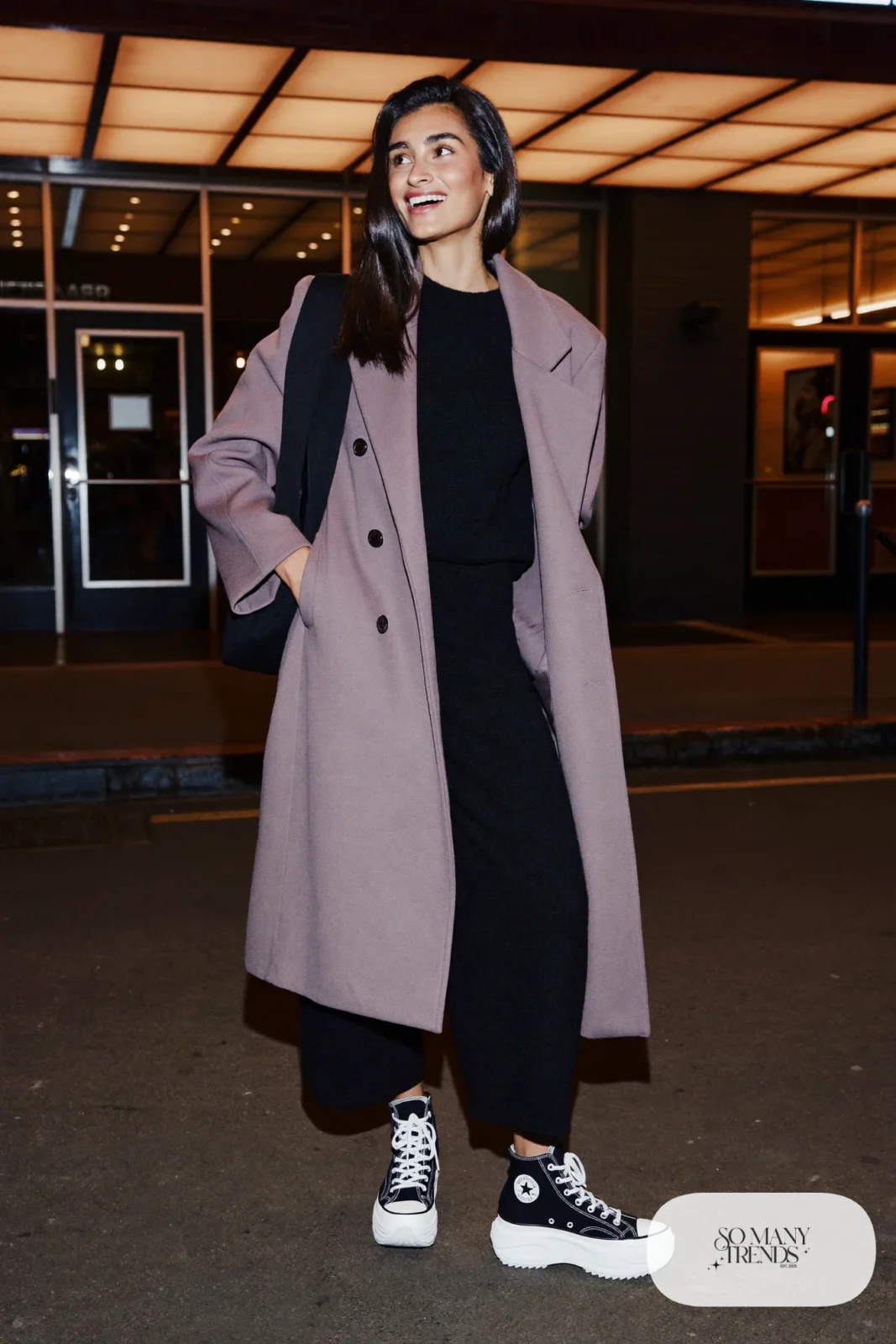 Woman in a long lavender wool coat, black knit sweater and pants set and black Converse Run Star Hike platform sneakers - outfit 7