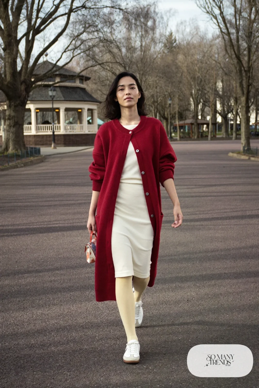 Long red knit cardigan over ivory midi dress with cream tights and white leather sneakers, outfit 28