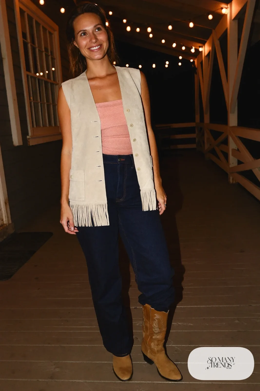Cream suede fringe vest, blush sparkle top, dark jeans, tan cowboy boots, look 9