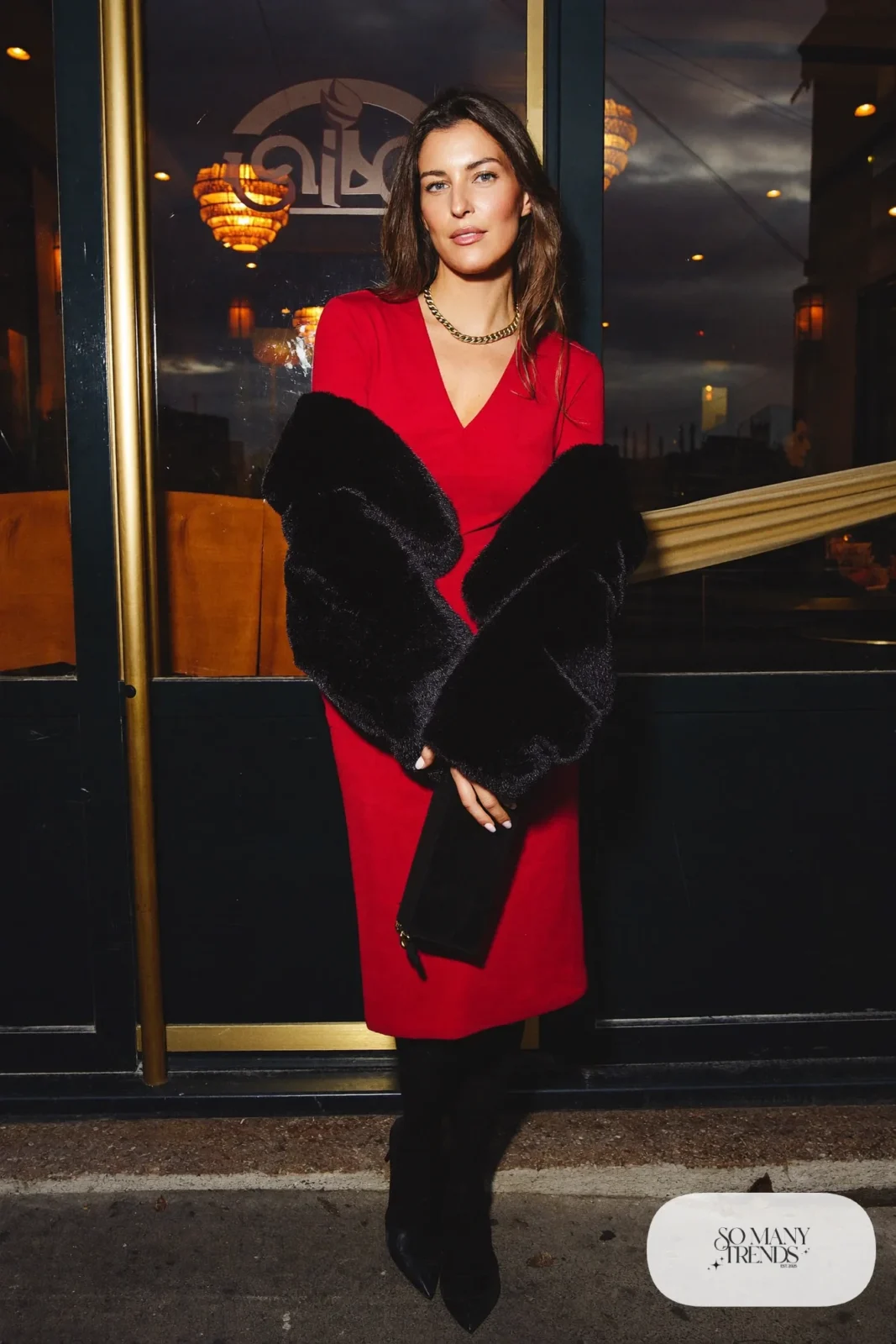 Woman in a red midi dress, cropped black faux fur jacket and black heels, look 27