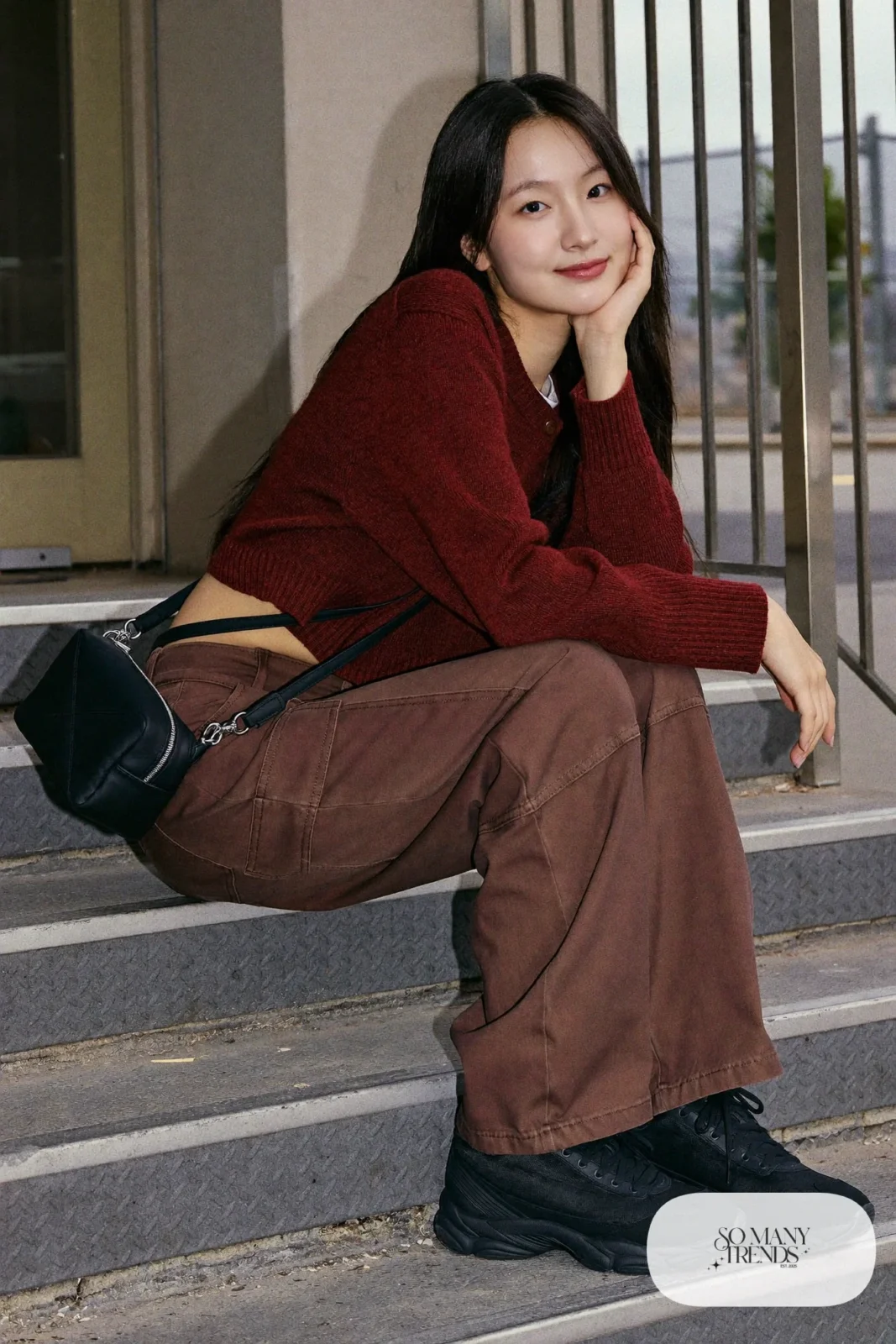 Woman in a burgundy sweater, brown cargo pants and chunky black sneakers, outfit 9
