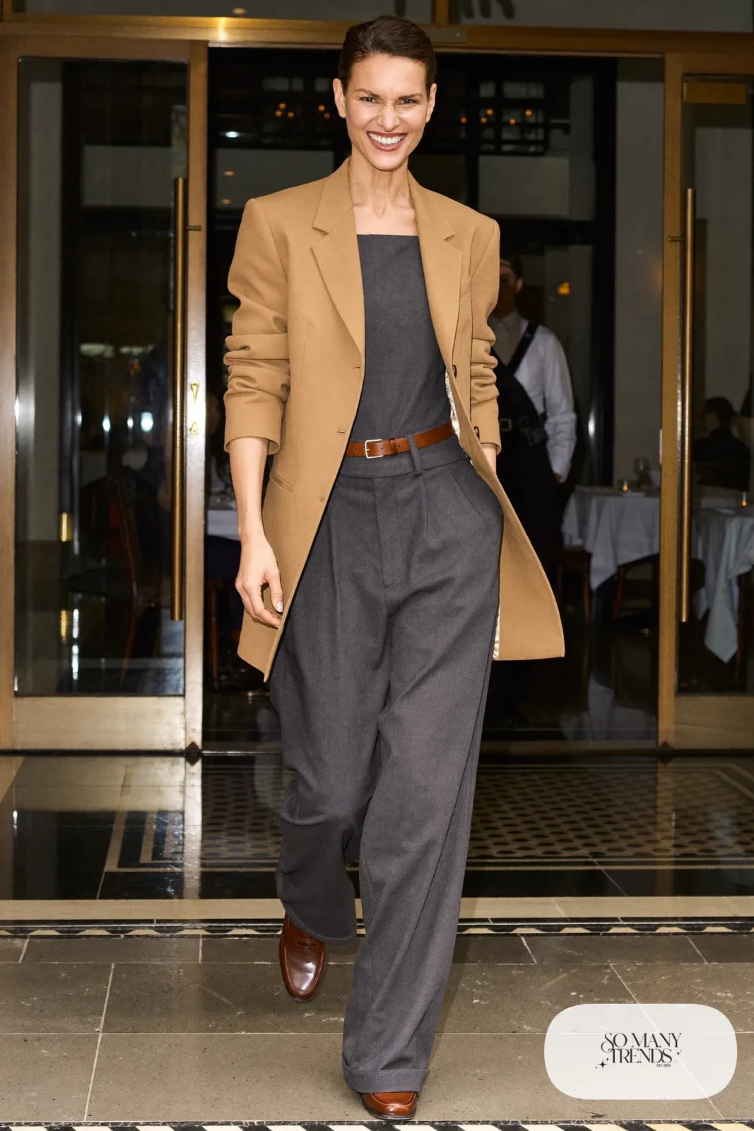 Gray wide-leg jumpsuit, brown leather belt, camel blazer and brown loafers, outfit 22