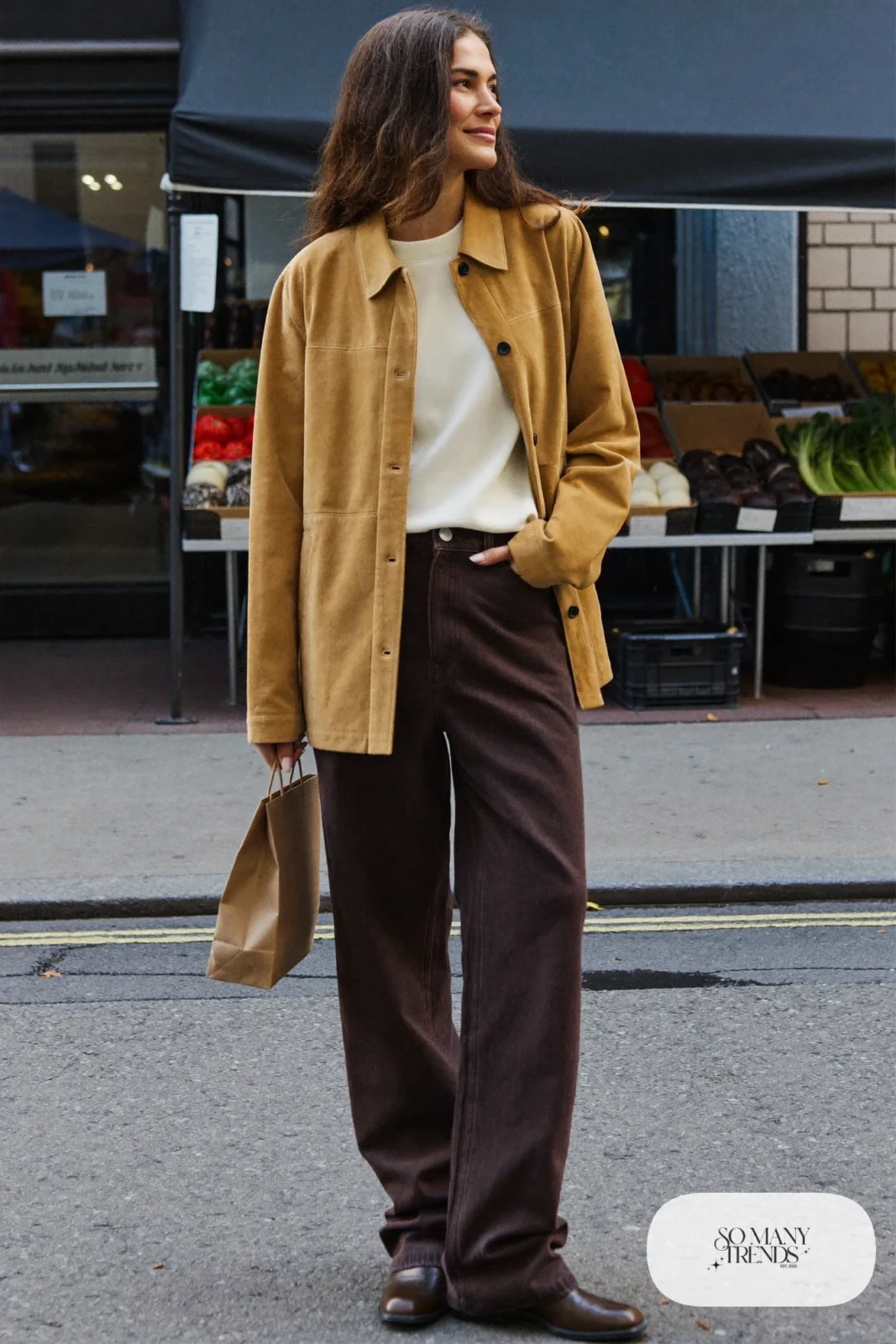Woman in a camel suede jacket, cream tee, eggplant straight jeans and brown leather boots, outfit 10