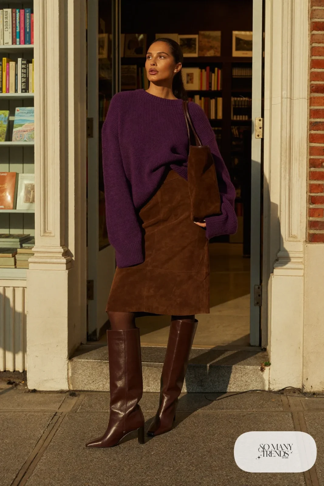 Woman in a plum ribbed sweater, chocolate suede midi skirt, sheer tights and brown leather ankle boots, outfit 15