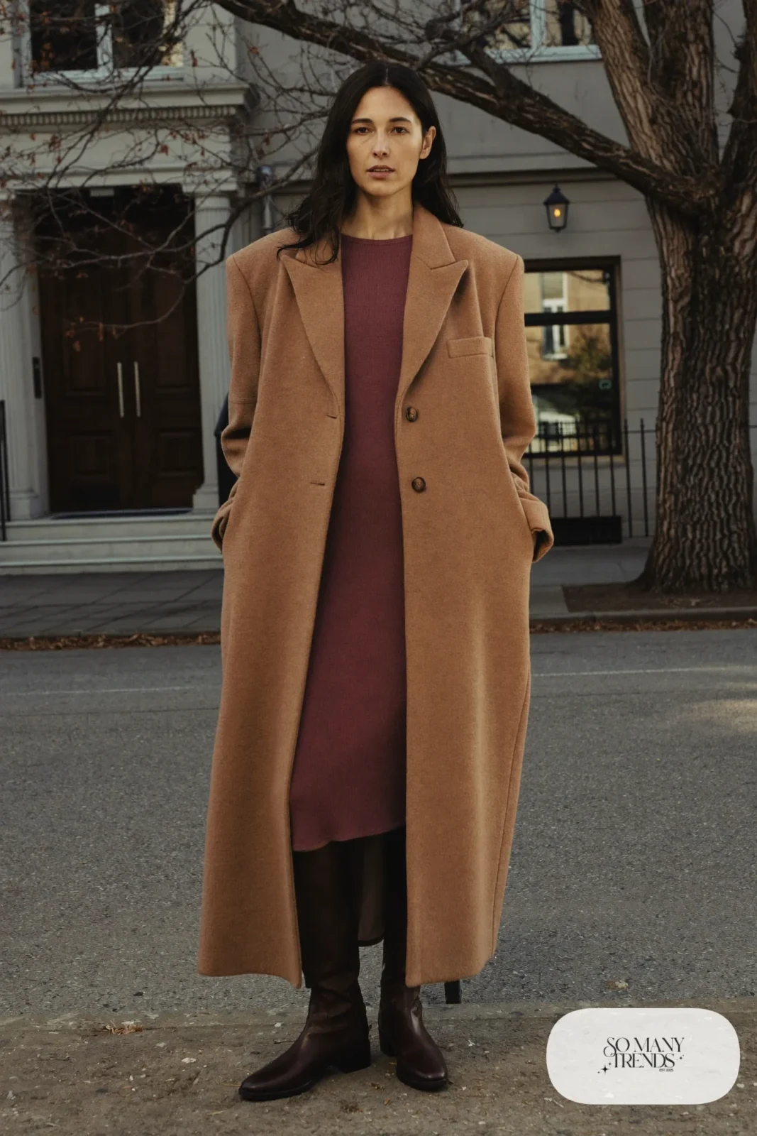 Woman in a camel wool overcoat, eggplant knit midi dress, sheer black tights and dark brown leather boots, outfit 16