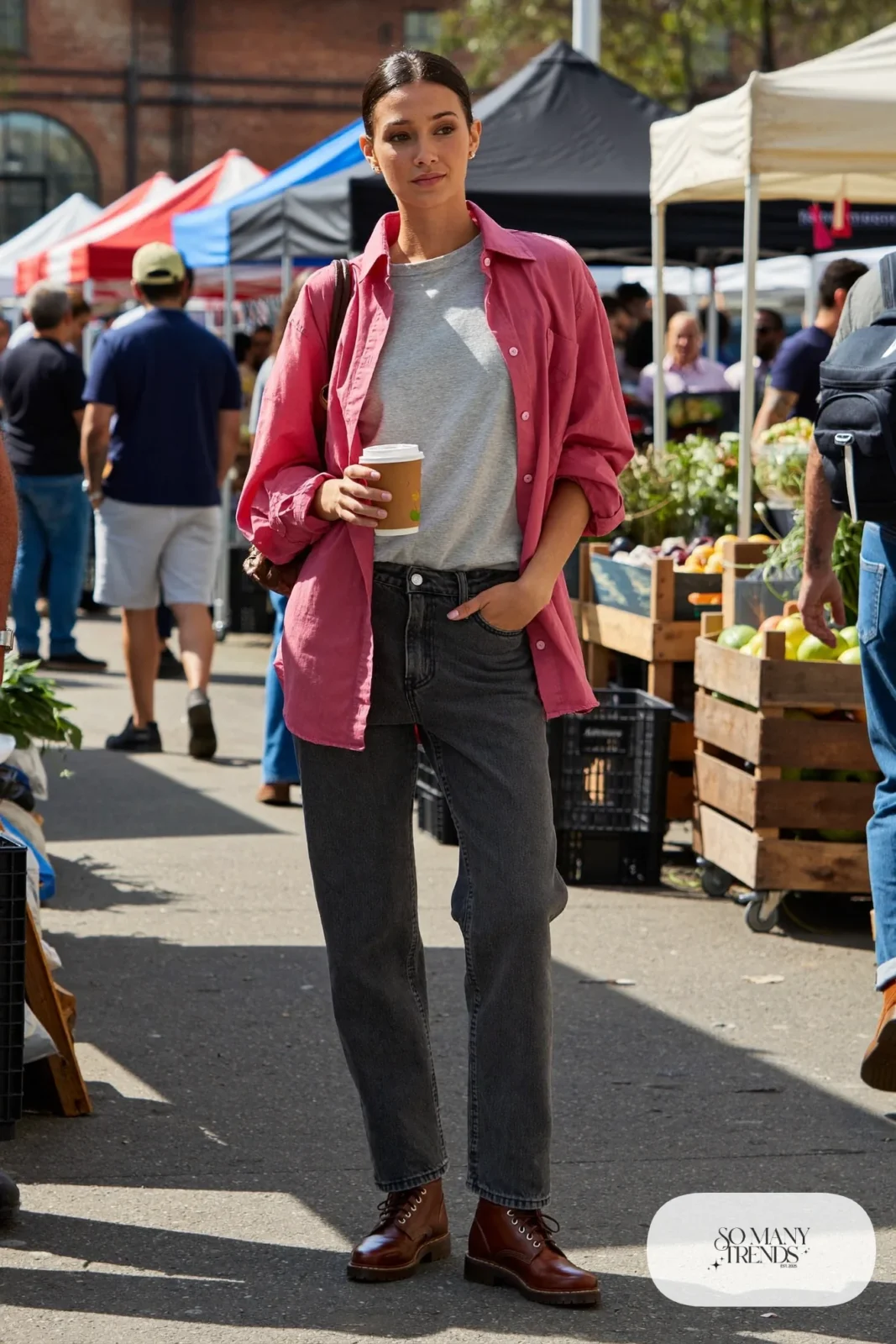 Woman in an open pink flannel shirt, gray tee, charcoal-wash straight jeans and brown boots, outfit 11