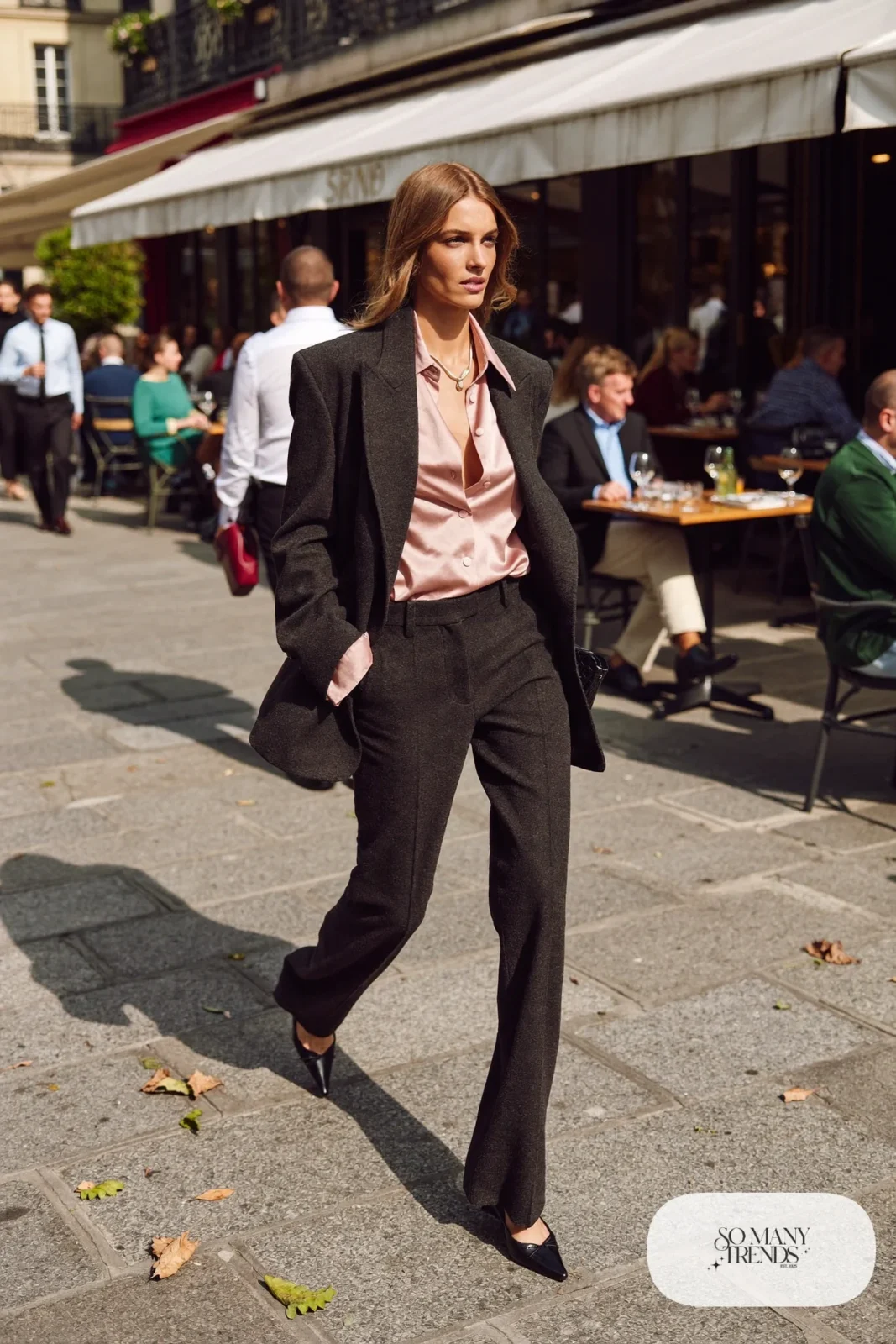 Woman in a blush satin blouse, charcoal blazer, charcoal wide-leg pants and black pumps, outfit 17