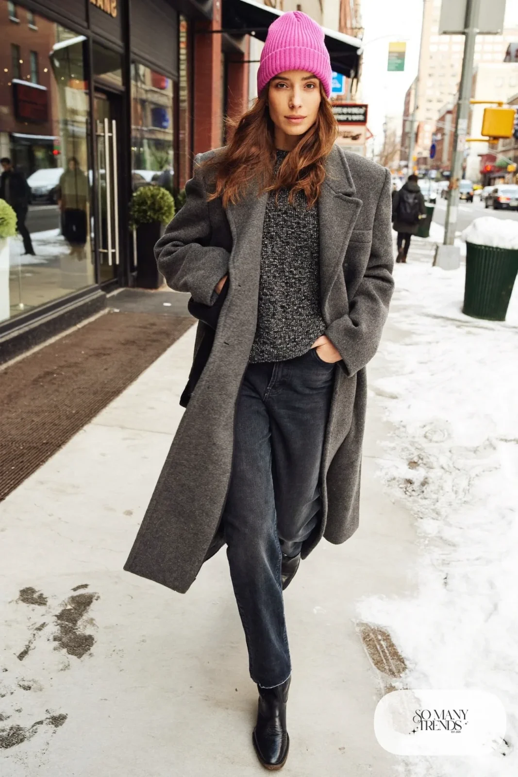 Woman in a long gray wool coat, pink knit beanie, dark straight jeans and black boots, outfit 31