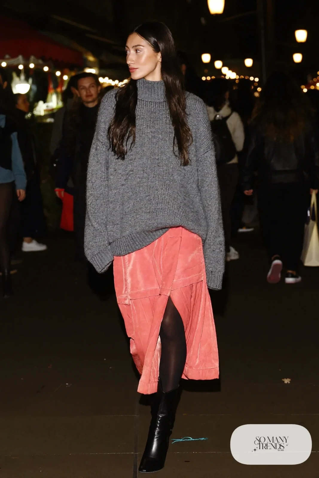 Woman in a chunky gray knit sweater, rose midi skirt, black tights and black lug-sole boots, outfit 21