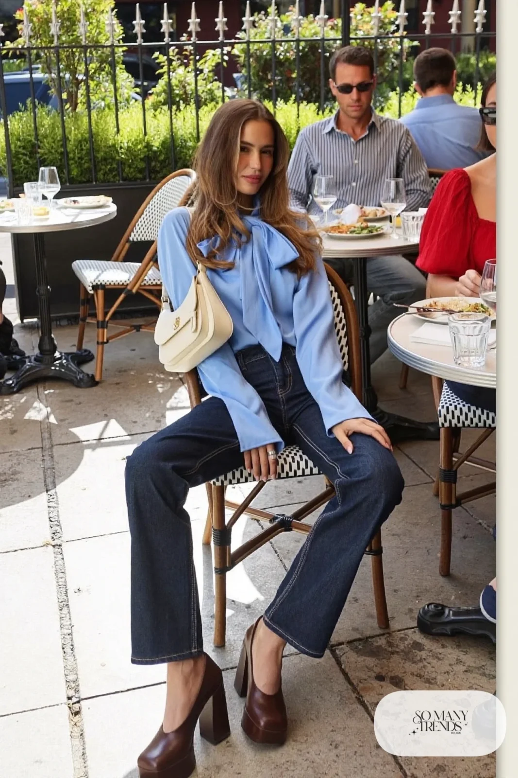 Woman in dark straight jeans, powder blue poplin blouse and chocolate platform pumps, outfit 7